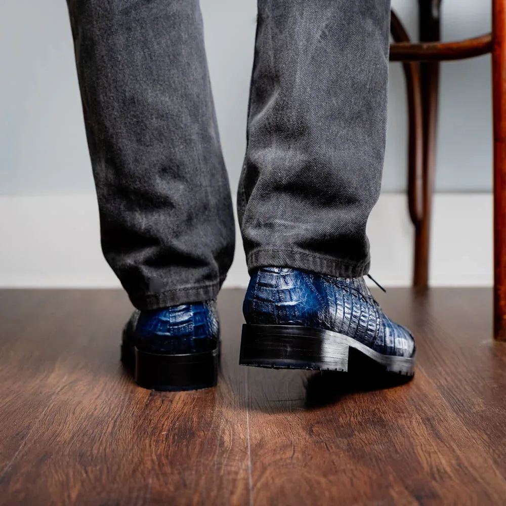 Close-up of Ragusa navy caiman derby shoe on foot showing leather texture and sole details.