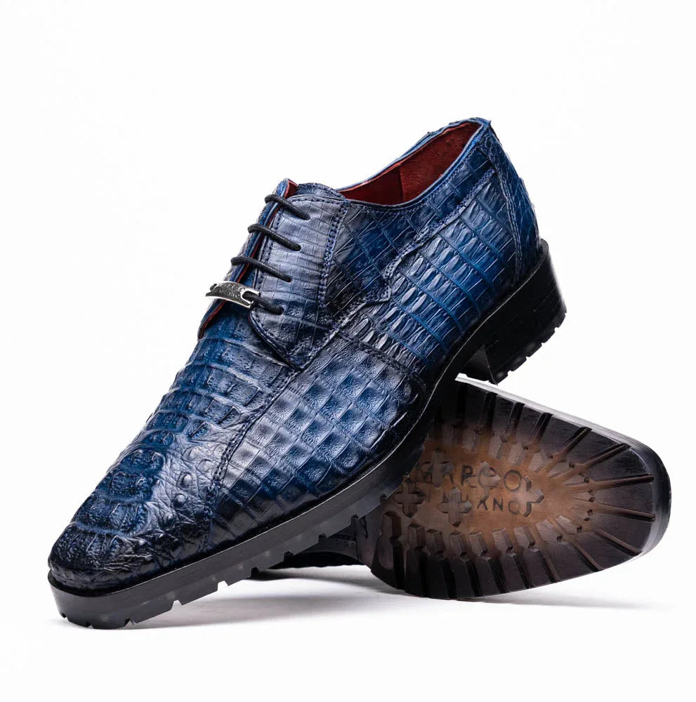 Close-up of Ragusa navy blue caiman crocodile leather derby shoe with hybrid sole on white background.