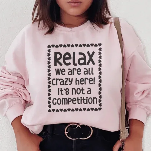 Light pink sweatshirt featuring white 'Relax We Are All Crazy Here' text centered on front.