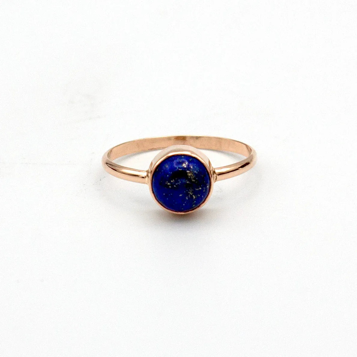 Side angle of 14k gold filled ring featuring 7mm round Lapis Lazuli gemstone in open bezel setting.