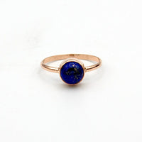 Side angle of 14k gold filled ring featuring 7mm round Lapis Lazuli gemstone in open bezel setting.