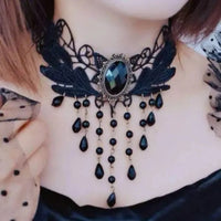 Black lace clavicular chain necklace laid out showing intricate floral lace design.