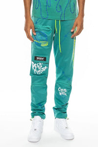 Sage green men's track pants with elastic waistband and visible zipper pockets
