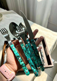 Flatware pieces arranged in a fan shape showcasing sleek modern styling