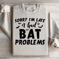 Sand-colored sweatshirt with Sorry I'm Late I Had Bat Problems text in white on front.