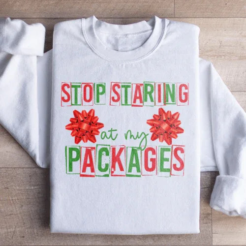White sweatshirt displaying 'Stop Staring At My Packages' text in black on the chest area.
