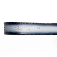 Detailed image of antique-finish Western belt buckle and textured leather on gray Texas belt.