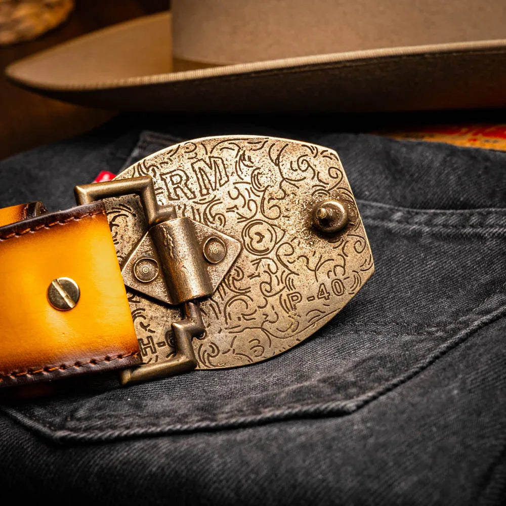 Man showing the textured surface of the Texas Belt in mustard brown worn with belt loops.