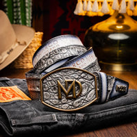 Lifestyle shot of model wearing gray Texas caiman and calfskin belt with Western buckle.