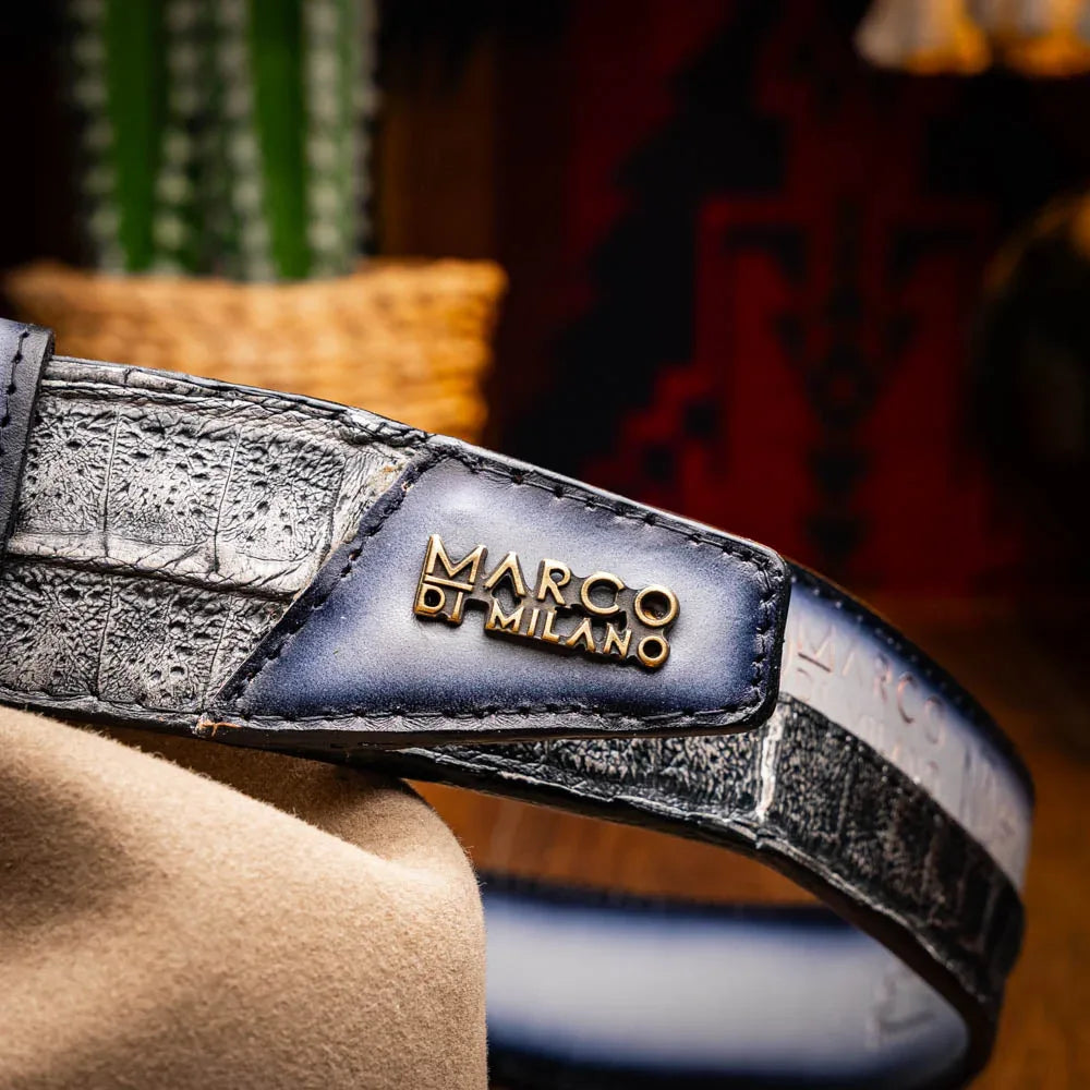 Model wearing jeans with gray textured Western belt showing belt buckle and embossed logo.