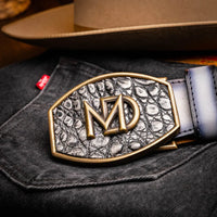 Close-up on waist of model wearing gray caiman crocodile belt paired with rugged outfit.