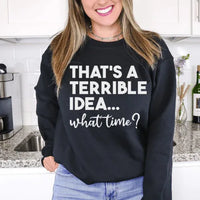 Close-up of peach sweatshirt showing 'That's A Terrible Idea' graphic on soft fabric.