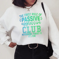 White sweatshirt featuring the phrase 'The First Rule Of Passive' in a peachy orange font on front