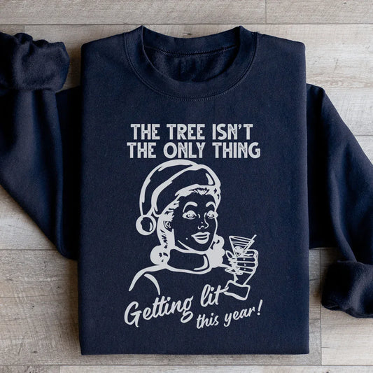 Black sweatshirt with text 'The Tree Isn't The Only One Getting Lit This Year' in playful font.