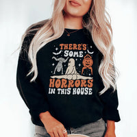 Black sweatshirt with white text 'There's Some Horrors In This House' in bold font.