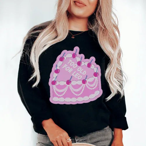 Close-up of black 'Too Old For Leo' sweatshirt showing fabric texture and fleece lining
