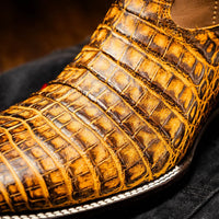 Close side view of Tucson Mustard Brown cowboy boot highlighting textured caiman belly skin.
