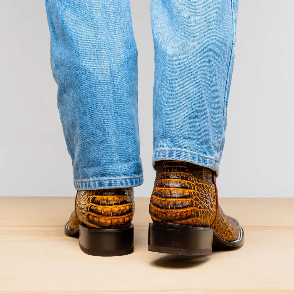 Close-up of Tucson Mustard Brown boot on foot, focusing on caiman texture and square toe design.