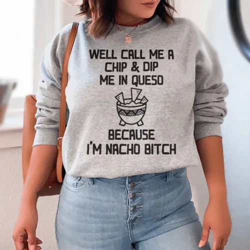 Close-up of sport grey sweatshirt showing soft fabric and detailed 'Well Call Me A Chip & Dip Me In Queso' print.
