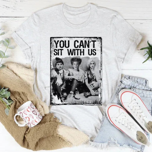 Ash-colored t-shirt featuring large black text 'You Can't Sit With Us' on front.