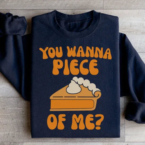 Close-up of black sweatshirt showing 'You Wanna Piece Of Me' text detail on soft fleece fabric.
