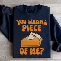 Close-up of black sweatshirt showing 'You Wanna Piece Of Me' text detail on soft fleece fabric.